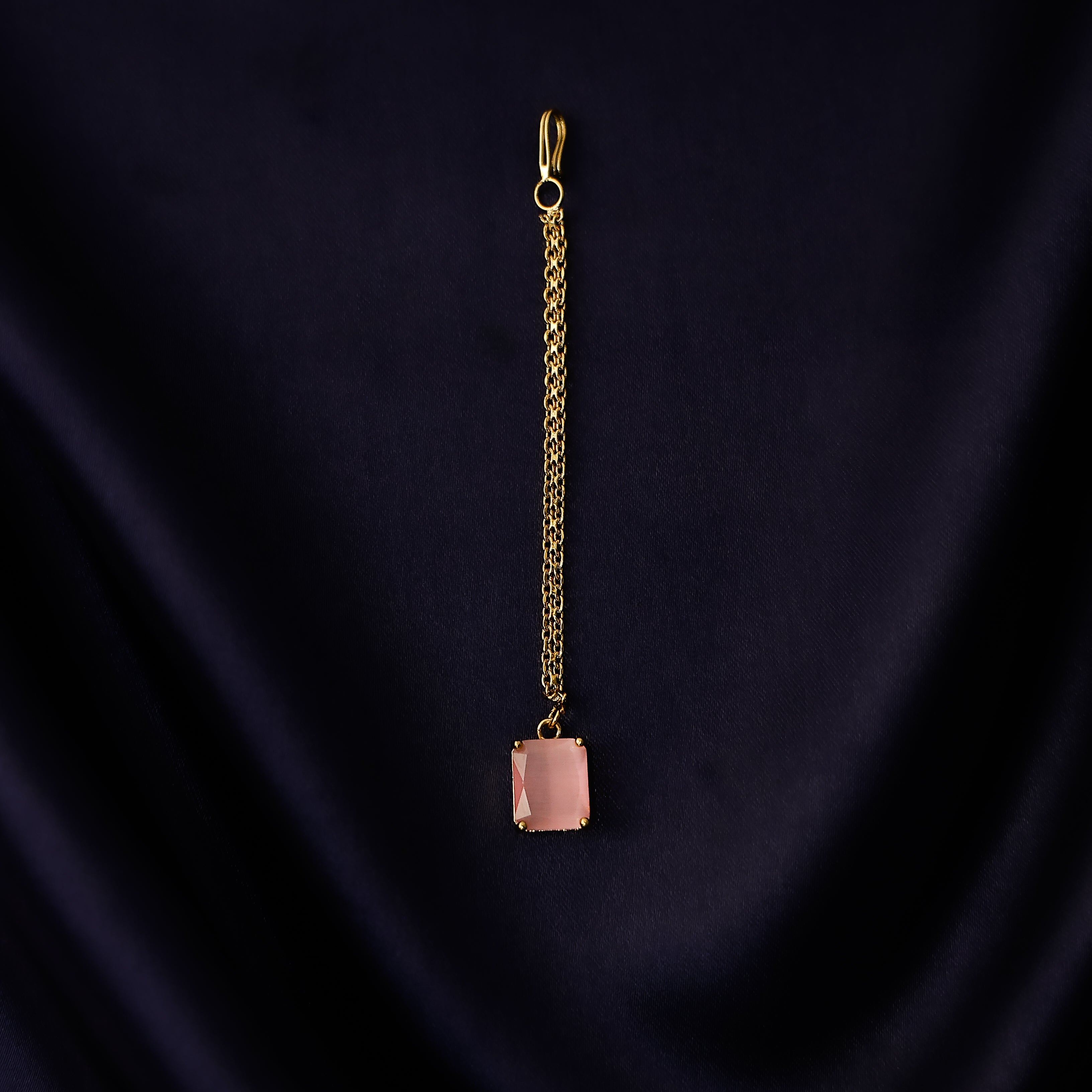 Minimal square gold tikka hanging elegantly on forehead