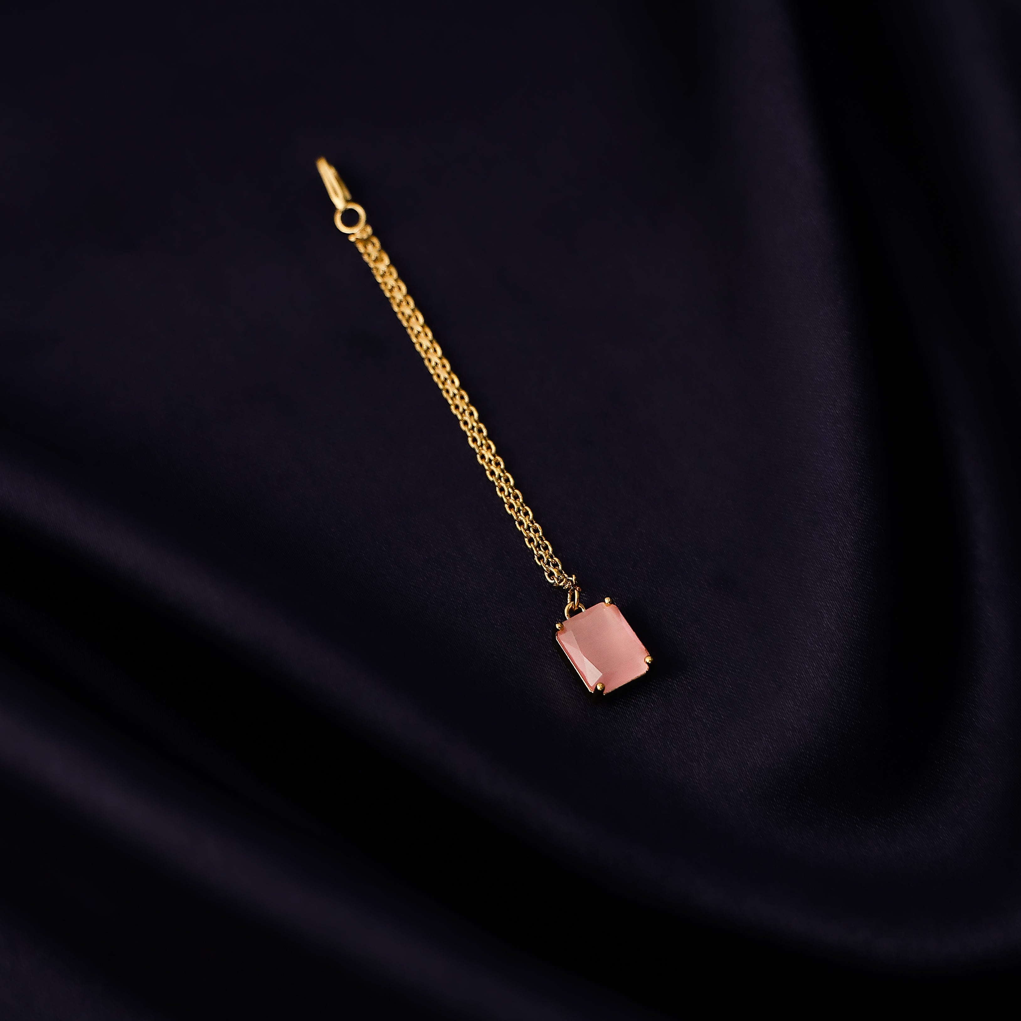 Close-up of square pendant tikka with fine gold finish detailing