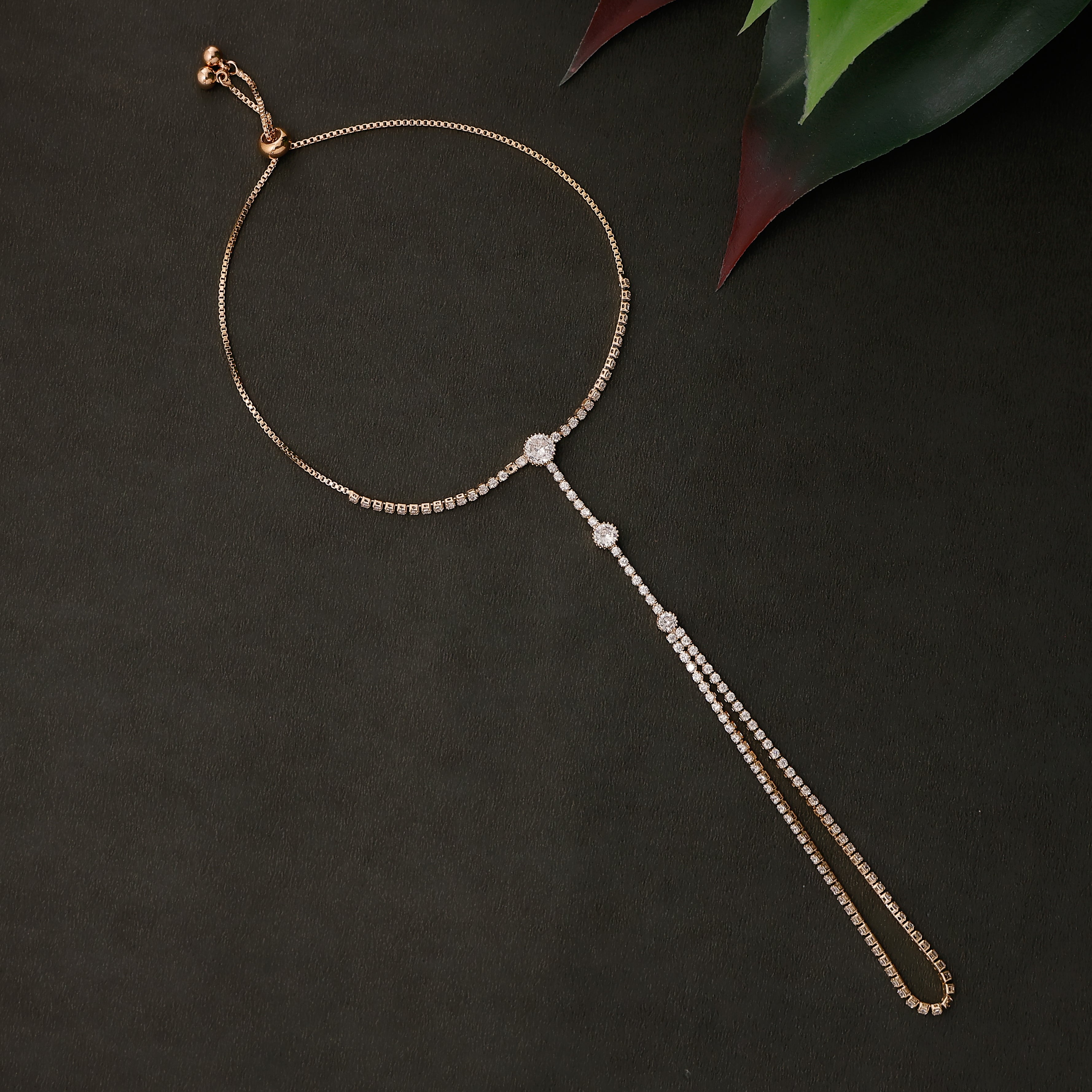 Gold tone crystal circle hath pan with bracelet and ring chain design