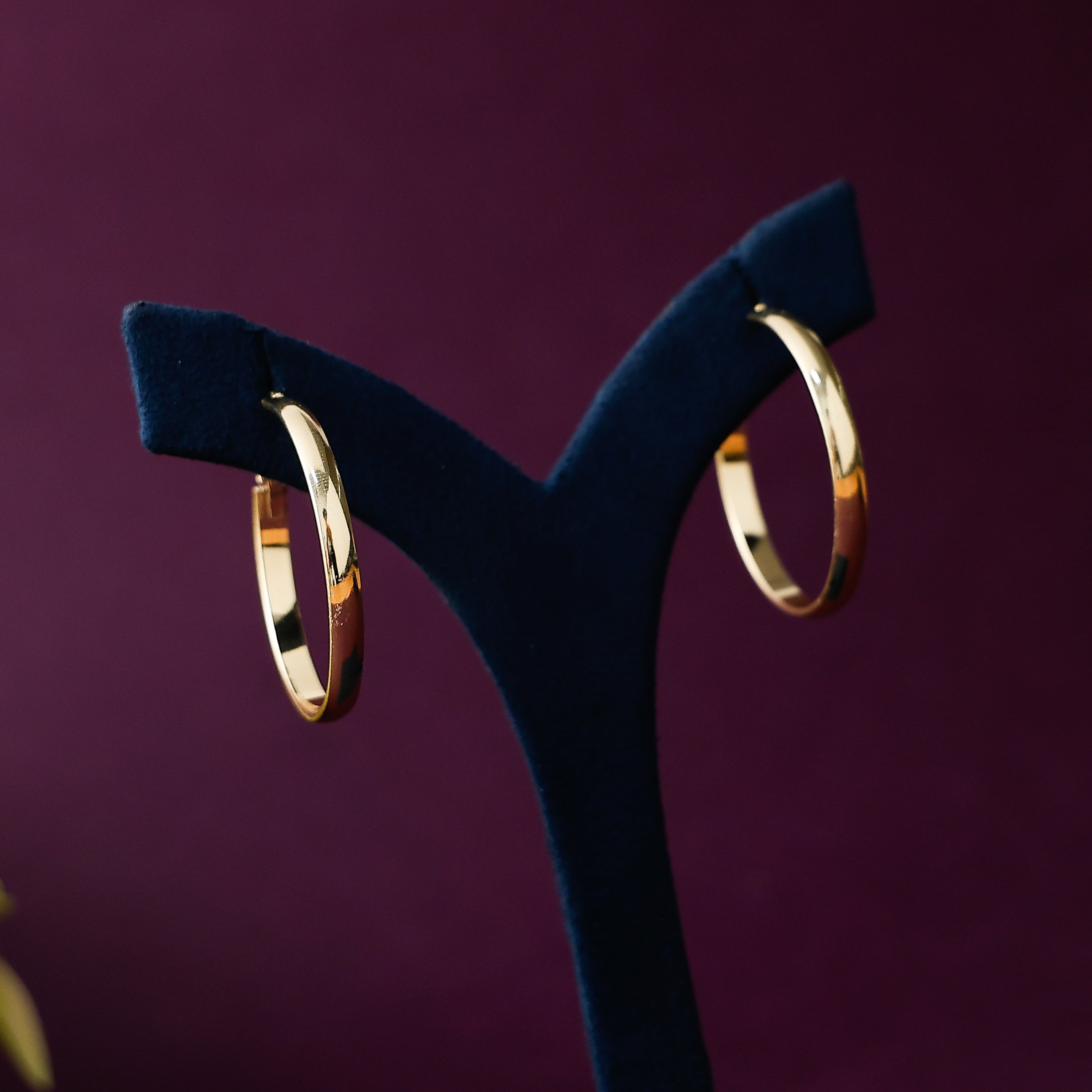 Golden rounded hoop earrings for women with polished gold finish